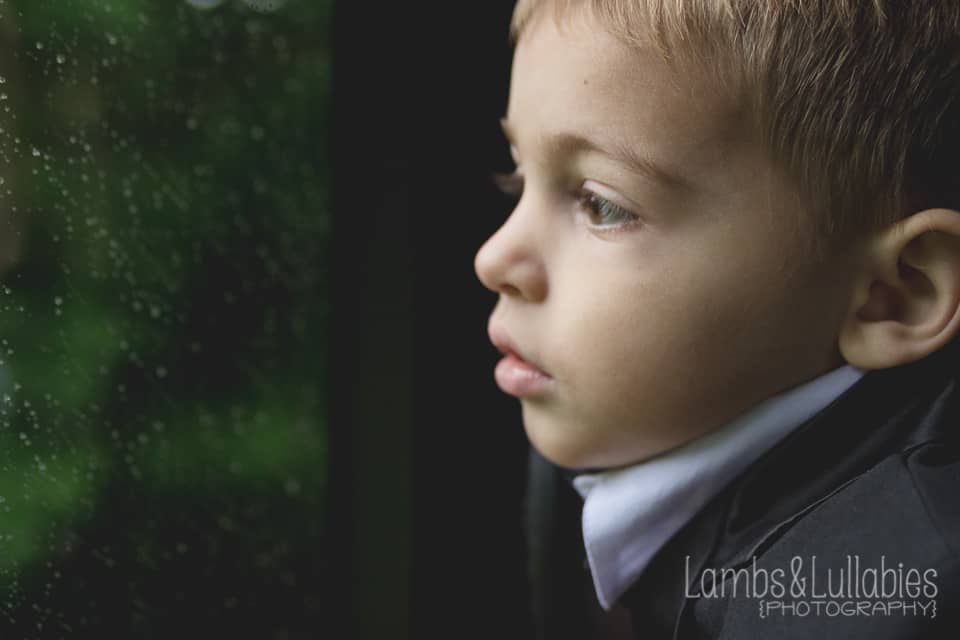 sad boy in window