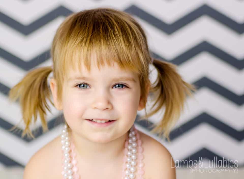 toddler girl in pearls