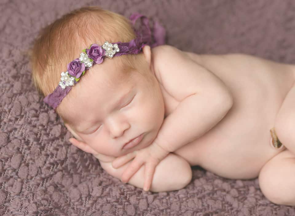 sleepy newborn in a flower headband