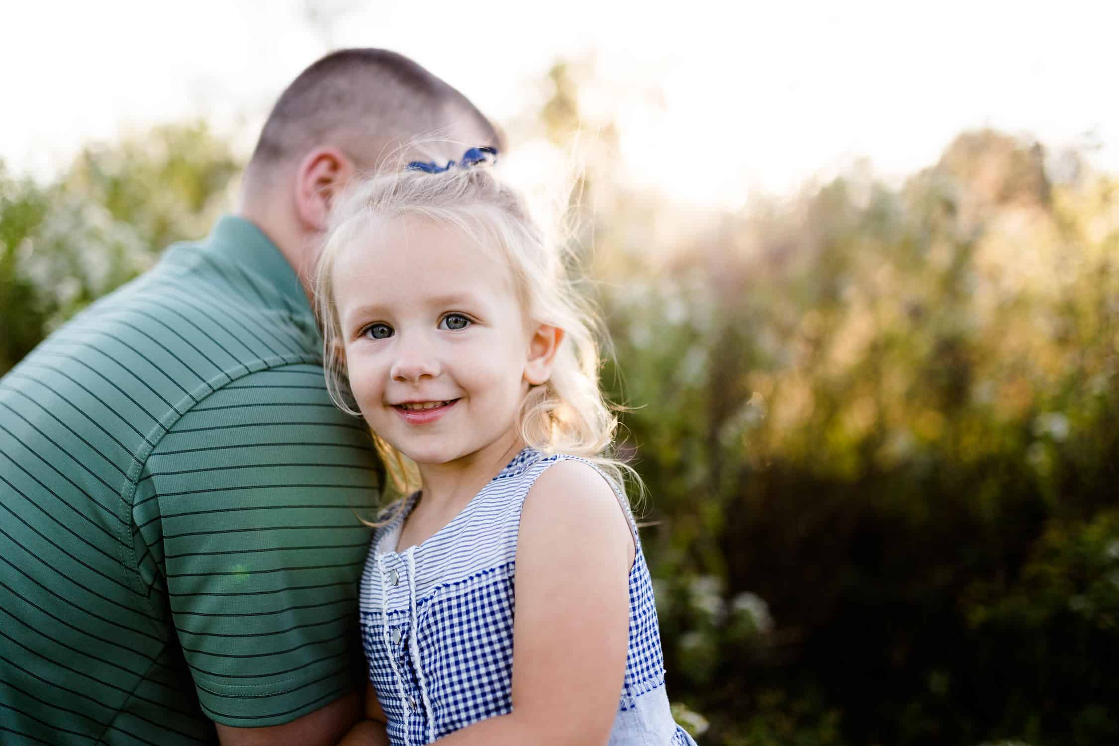 Dad and daughter playing in a field