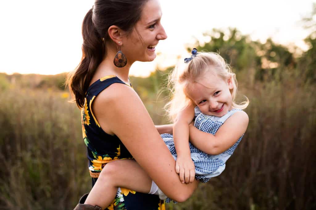 Mother and daughter having fun and spinning in circles for their family photos