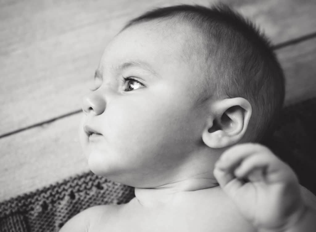 6 month old baby boy looking off into the distance