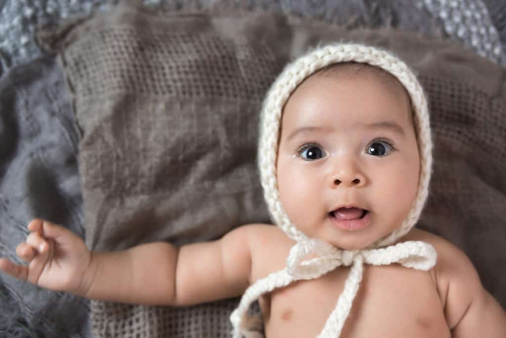 Baby boy in bonnet for 3 month old milestone photoshoot