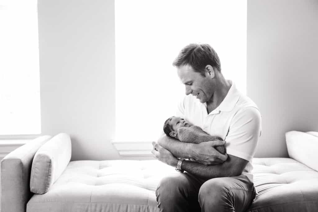 Kansas city newborn photographer baby and dad image with smiling