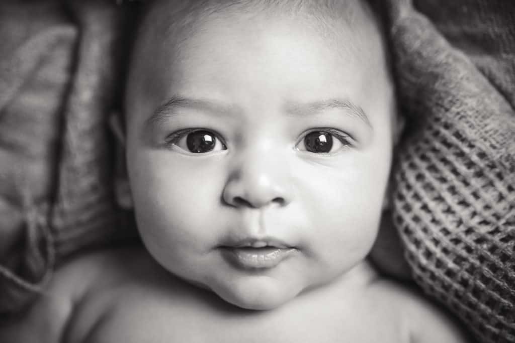 Kansas city newborn photographer baby boy staring into camera