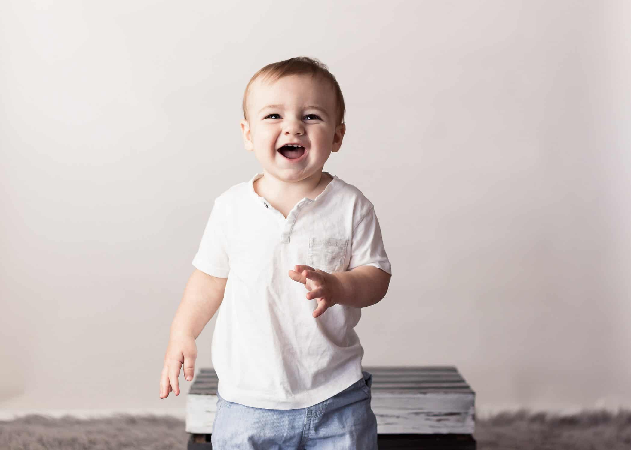 Baby boys first birthday session smiling at the camera