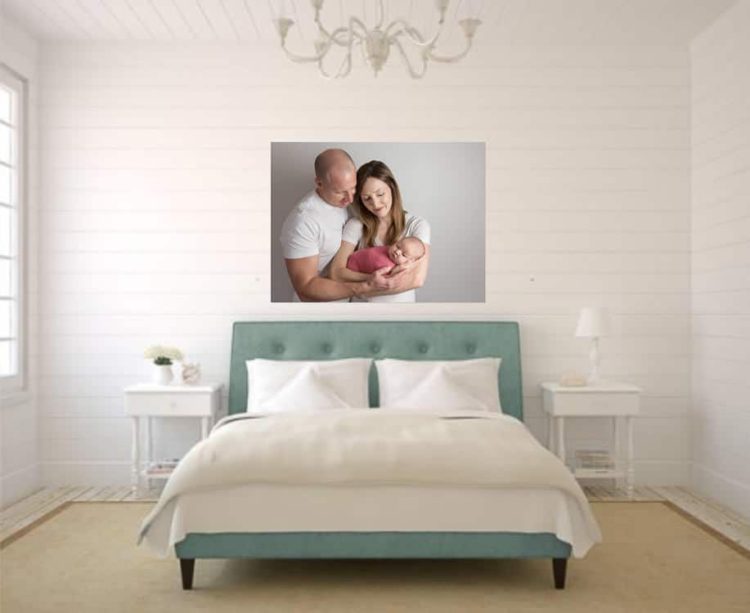 Newborn photo with parents on canvas wall art in bedroom